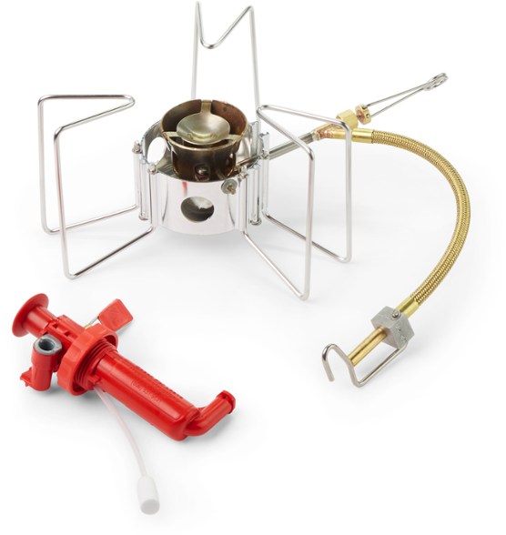 Close-up side view of the MSR Dragonfly backpacking stove set up on rocky terrain