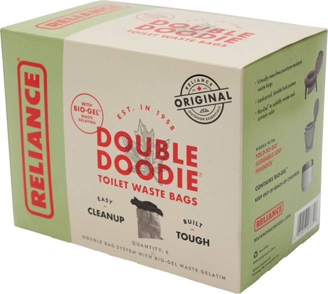 Double Doodie waste bags displayed outdoors, ideal for camping sanitation needs.