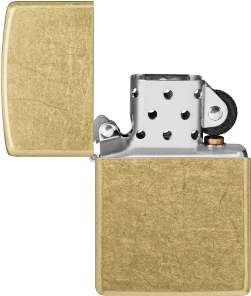 Classic Zippo lighter on a wooden table with camping gear.