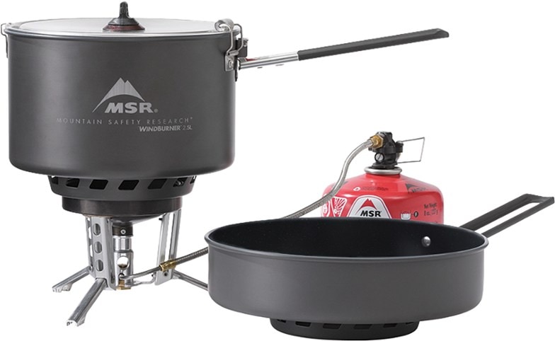 MSR WindBurner Combo Stove System set up in the wilderness, cooking a meal.