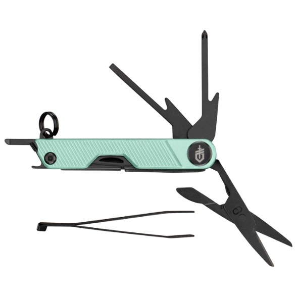 Compact keychain tool with scissors, displayed open against a rustic background.