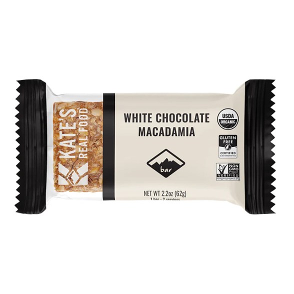 Close-up of creamy white chocolate macadamia energy bar on a rustic wooden table.