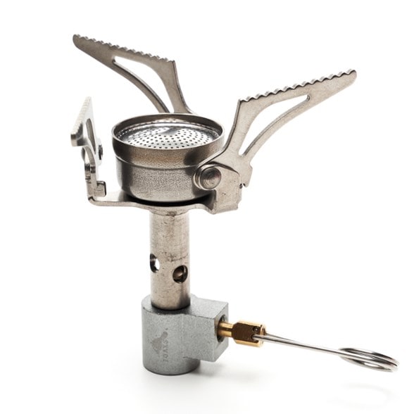 TOAKS Titanium Backpacking Stove shown in a camping setting with pot on top, highlighting its compact design.