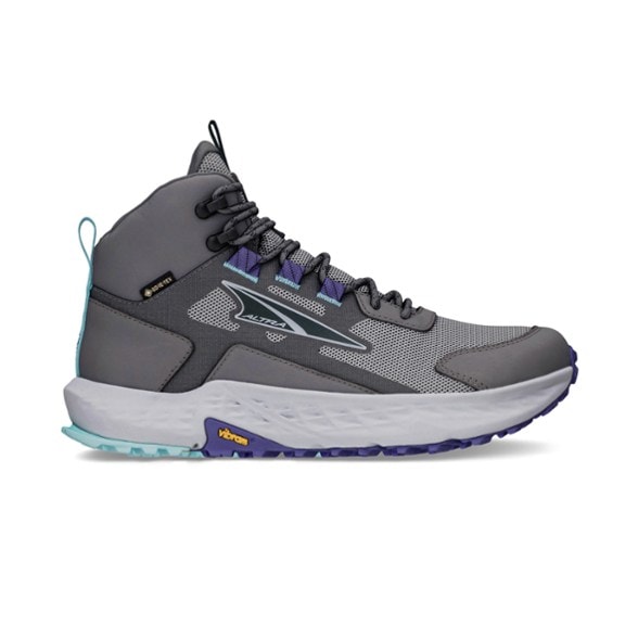 Altra Timp 5 GTX Women's Hiking Boots on rocky terrain, highlighting grip and waterproof features.