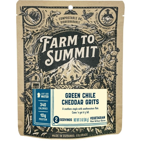 Close-up of Farm to Summit green chile grits with cheddar cheese sauce served in a camping bowl