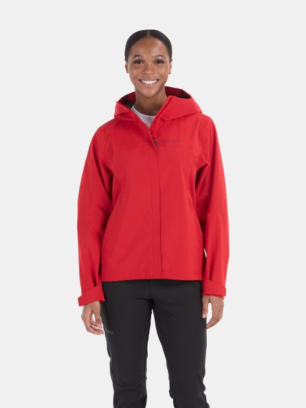 Marmot Eco Pro Women's Rain Jacket in action during a hike, showcasing its waterproof features.