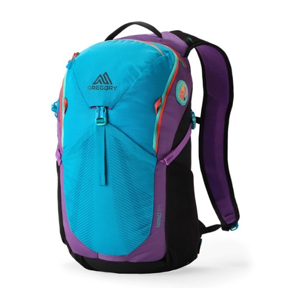 Gregory Nano 24 backpack in use on a mountain trail, showcasing its spacious design and hydration reservoir compartment.