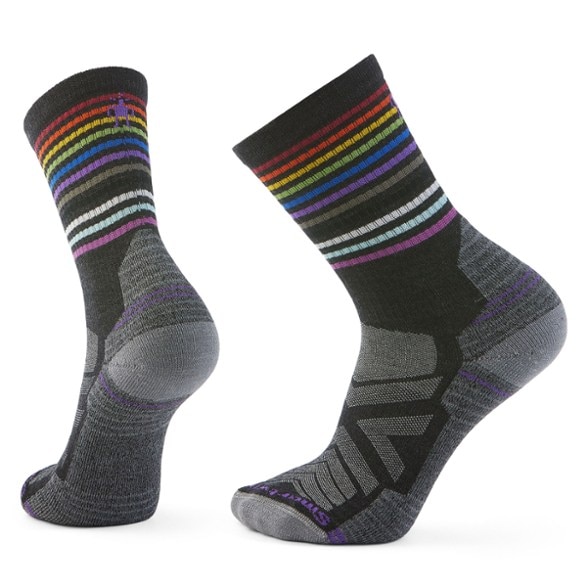 Pride crew light cushioning hiking socks displayed on a rocky trail