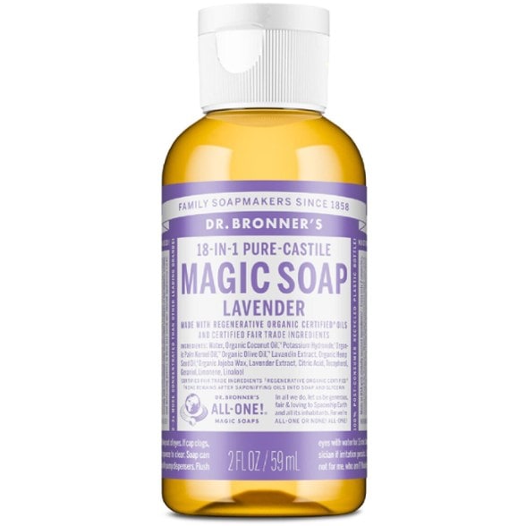 Close-up of EcoWander liquid soap bottle placed on a mossy rock, highlighting its travel size.