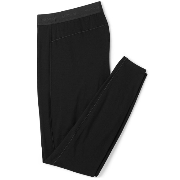 Front view of women's merino wool base layer bottoms in a scenic hiking background.