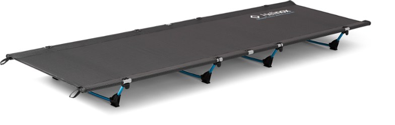 Helinox Lite Portable Camping Cot in a forest setting, showcasing its compact design.