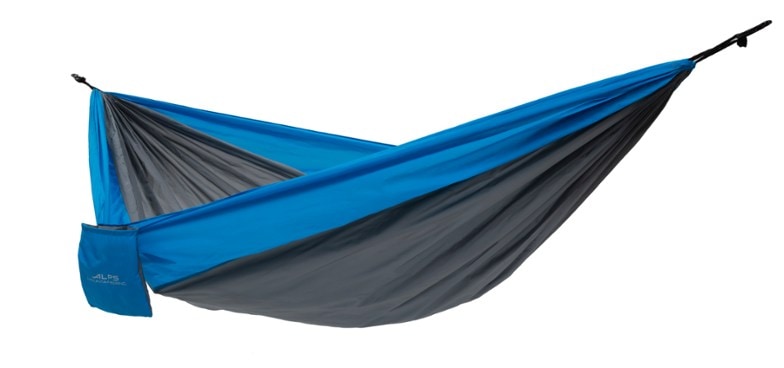 ALPS Cirrus hammock set up between two trees in a forest, showcasing its lightweight design.
