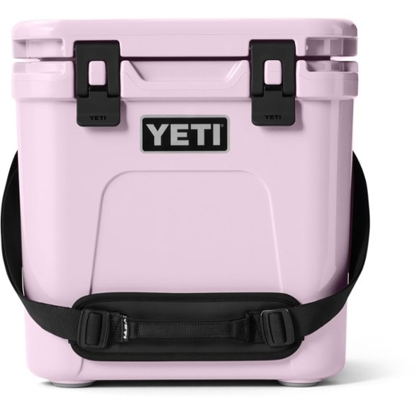 Yeti Roadie 24 hard cooler showing its portability and features.