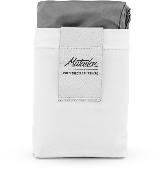 Ultimate portable waterproof blanket laid out on grass, showcasing its spacious design.
