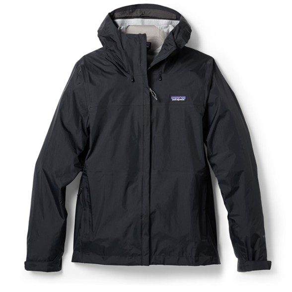 Patagonia women's packable waterproof rain jacket in action during a hike, showcasing its water-resistant features.