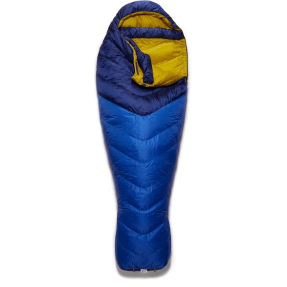 Rab Neutrino 400 sleeping bag in a scenic mountain setting, showcasing its lightweight design.