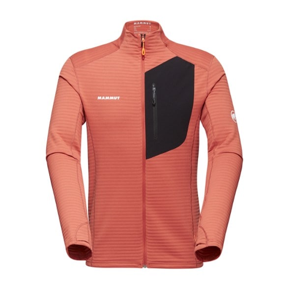 Front view of men's jacket in alpine setting showing thumbholes and chest pocket.