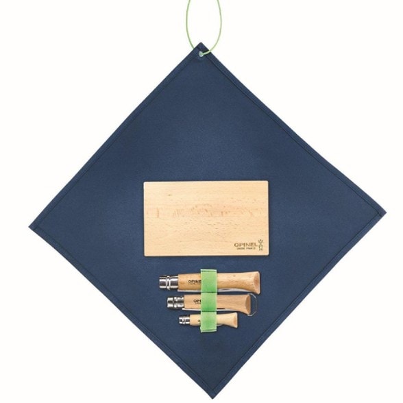 Nomad Adventure Cooking Set laid out on a picnic table, showcasing its folding knife, corkscrew, and cutting board.