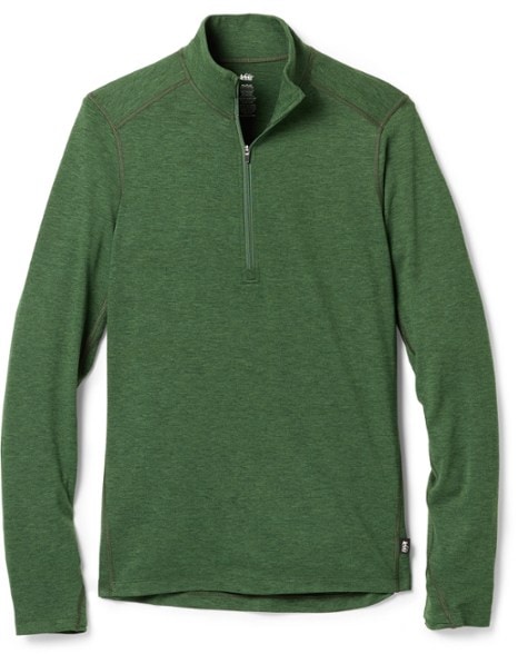 Women's midweight half-zip base layer top shown in outdoor setting, ideal for skiing.