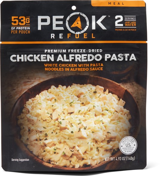 Peak Refuel Chicken Alfredo Pasta meal in a camping setting, showcasing its creamy texture and real chicken.