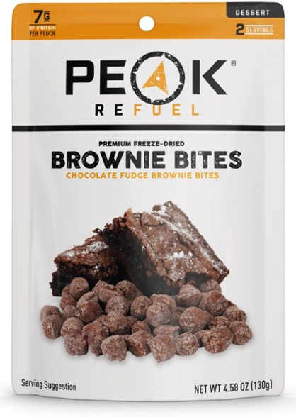 Peak Refuel Fudge Brownie Bites in a scenic outdoor setting, showcasing its portability for camping.