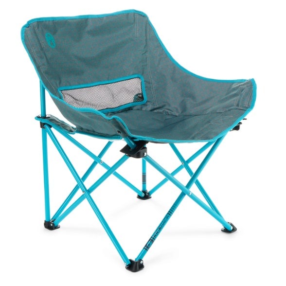 Coleman Kickback Breeze Portable Chair in a park setting, showcasing its lightweight design and comfortable fabric.