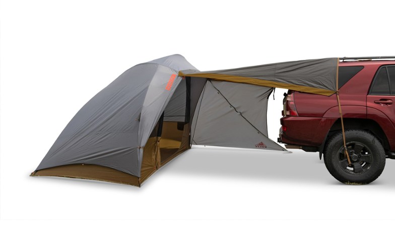Kelty Caboose vehicle tent attached to a car with extended awning providing extra family camping shelter