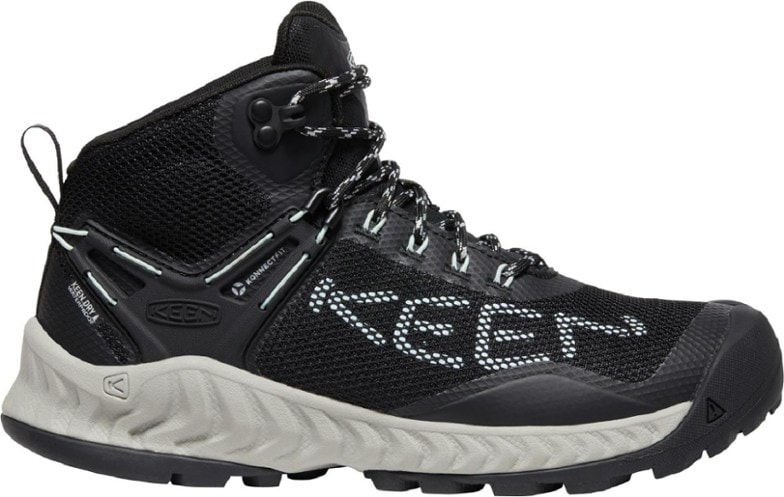 Side view of KEEN NXIS EVO Mid Waterproof Hiking Boots for Women showcasing the durable upper and ankle support.