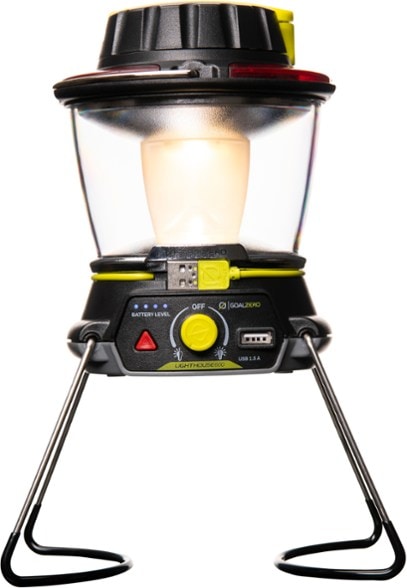 Lighthouse 600 lantern shining brightly at a campsite with a USB power hub.