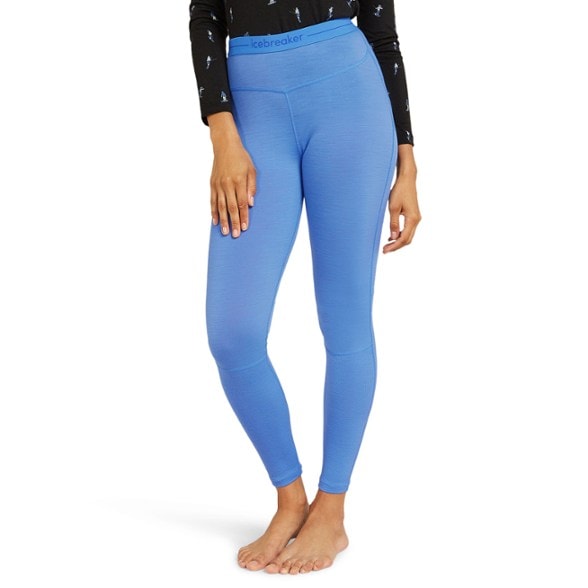 Icebreaker Women's 200 ZoneKnit thermal leggings in action during a winter hike.