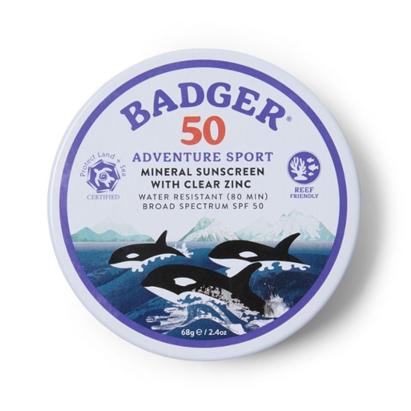 Eco-Adventure SPF 50 Mineral Sunscreen Tin with outdoor scenery in the background.