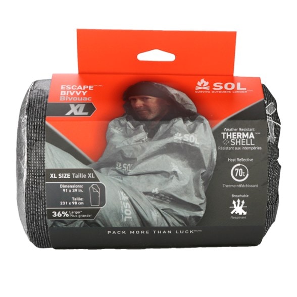 Escape Bivy XL shown in a forest setting, demonstrating its waterproof capabilities and hood design.