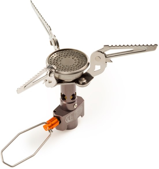 UltraLite Canister Stove showcased in a forest setting, used for cooking a meal.