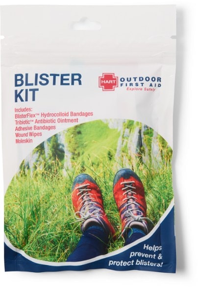 Flat lay of the TrailGuard blister kit showing bandages, ointment, and moleskin for hiking first aid