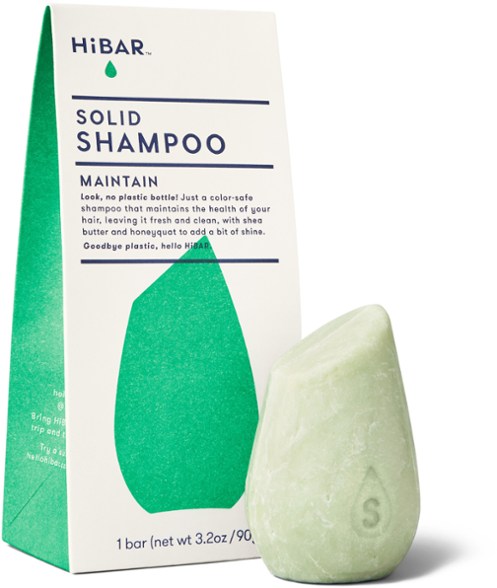 Close-up of the HiBAR shampoo bar resting on a bamboo tray, showcasing its compact size and eco friendly packaging
